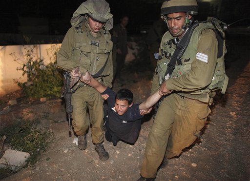 Israeli soldiers detain a Jewish settler after he 