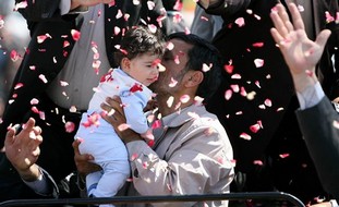 Ahmadinejad hugs an Iranian child in 2009 file photo