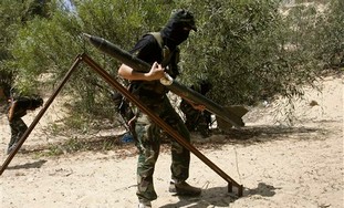 A Palestinian Islamic Jihad militant holds a rocke