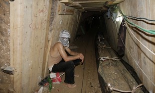 Palestinian sits in Egypt-Gaza smuggling tunnel