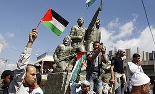 Syrians hold Palestinian flags in Majdal Shams