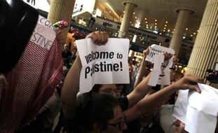 Israeli activists protest at B-G airport, Friday.