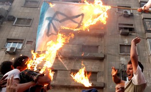 Cairo: Protesters burn an Israeli flag 
