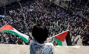 Palestinian boy looks over rally in Ramallah