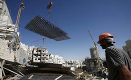 Palestinians work on a construction site