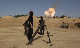 Palestinian terrorists fire a mortar shell in Gaza