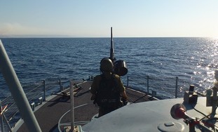 Sailor mans cannon during routine Red Sea patrol