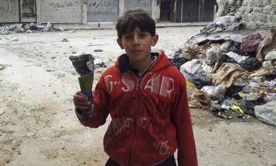 Boys hold remains of mortar in Homs neighorhood 