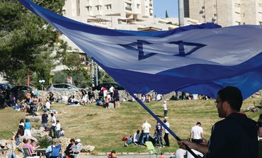 Man waves Israeli flag in Jerusalem