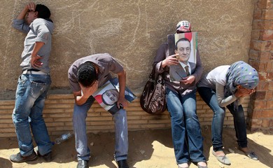 Supporters of deposed president Hosni Mubarak react after a court sentenced him to life