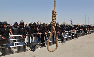 A noose is seen near police standing guard outside the police academy where former Egyptian President Hosni Mubarak is on trial
