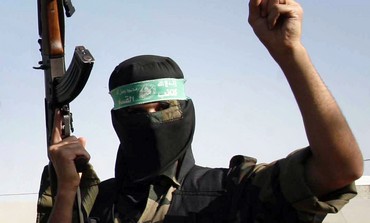 A masked Hamas man holds a gun [file]