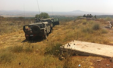 ISRAELI SOLDIERS keep watch over the Syrian border