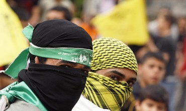 Palestinians wearing Hamas, Fatah masks