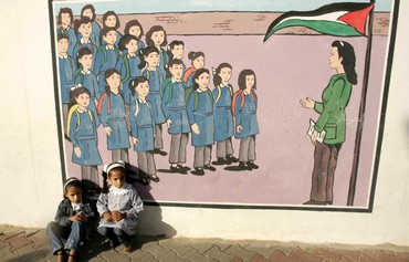 Palestinian kids sit at UNRWA school