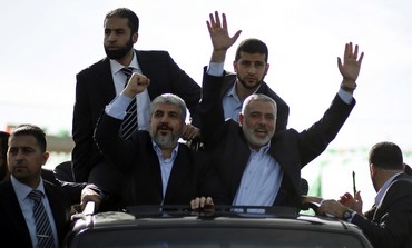 Hamas leader Khaled Mashaal [left] arrives in Gaza