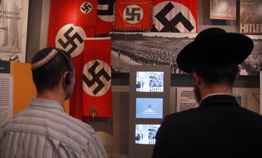 Jewish men looking at Holocaust exhibit in Yad Vashem, January 27, 2013.