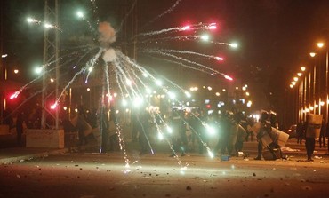 Egyptian protesters throw fireworks at police, Feb. 1, 2013