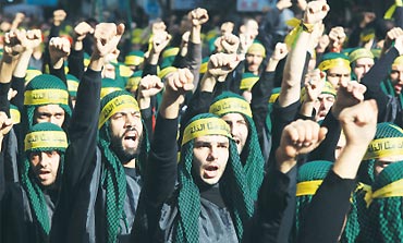 Hezbollah supporters march in Beirut’s suburbs
