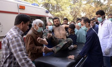 Residents move a Syrian Army soldier, wounded in apparent chemical weapon attack, March 19, 2013.