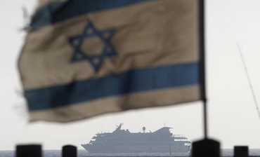 Israeli flag flutters as Mavi Marmara escorted to Ashdod port May 31, 2010.