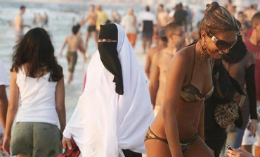 A secular woman enjoys the beach in Alexandria, Egypt