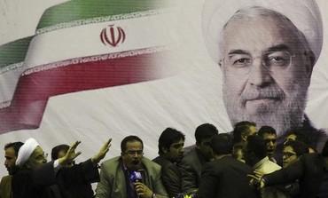 Iranian presidential candidate Hassan Rohani (L) waves to supporters