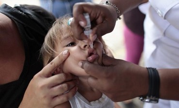 A child receives polio vaccination drops in Managua April 15, 2013.
