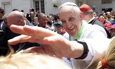 Pope Francis extends his hand.