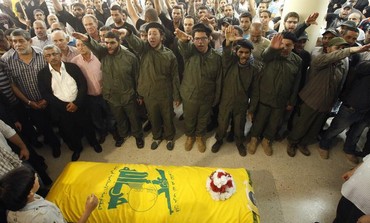 Supporters of Hezbollah and relatives gesture during a funeral.