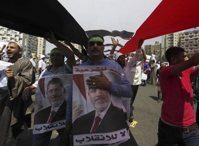 Pro-Morsi protesters shout slogans during a rally in Cairo.