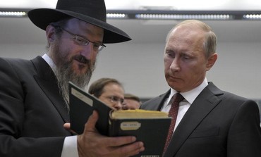 Russia's President Vladimir Putin listens to Russia's Chief Rabbi Berel Lazar at tolerance center.