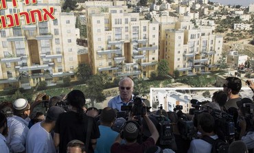 Housing Minister Uri Ariel speaks to reporters at a ceremony announcing construction in east J'lem.