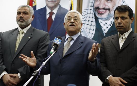 Palestinian president Abbas stands between PM Haniyeh and senior Fatah leader Dahlan in Gaza