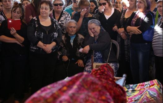Relatives and friends mourn during the funeral of Reuven Aviram, 51