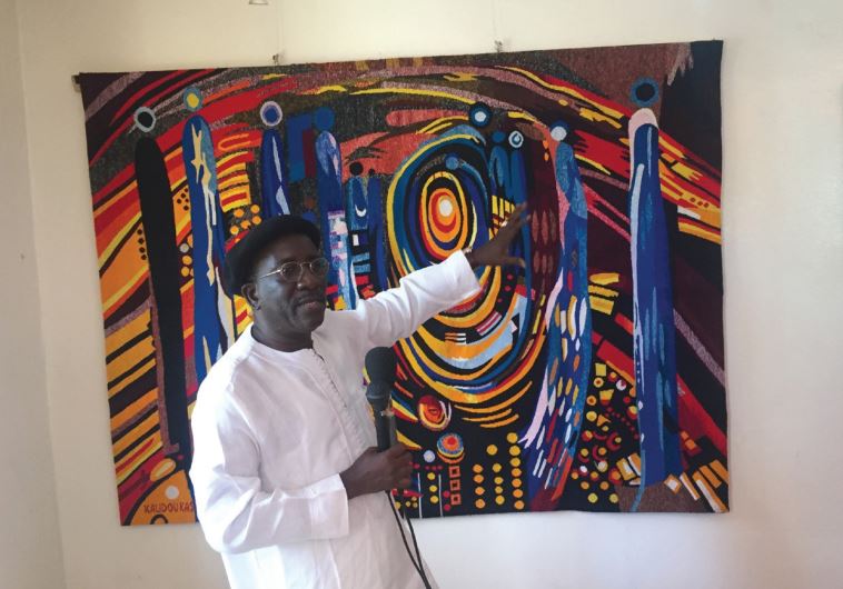 Kasse, a local artist shows some of his recent work at his studio in Dakar