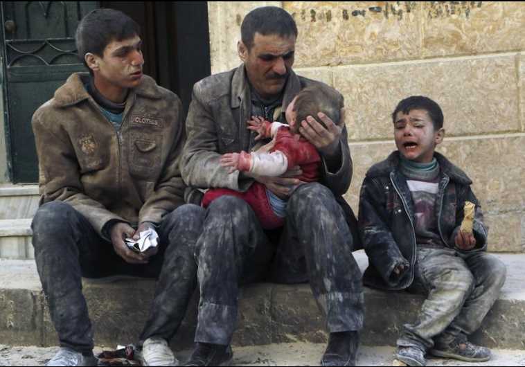 A man holds a baby saved from under rubble