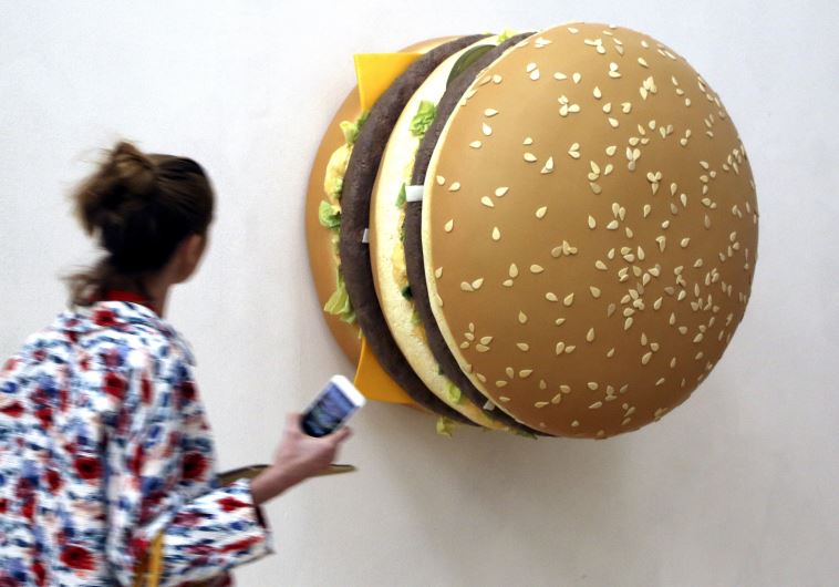 A woman looks at a creation by Tom Friedman named 'Big Big Mac' 