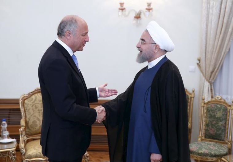 Iran's President Hassan Rouhani (R) welcomes French foreign minister Laurent Fabius in Tehran 