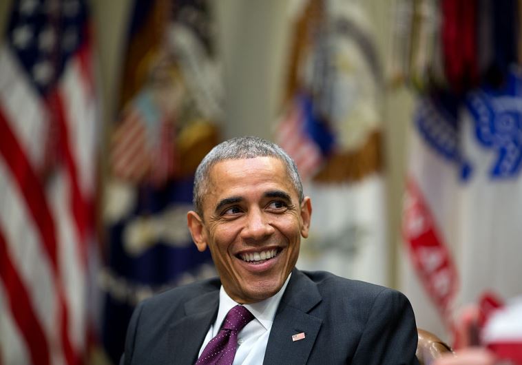 US President Barack Obama laughs during a meeting at the White House