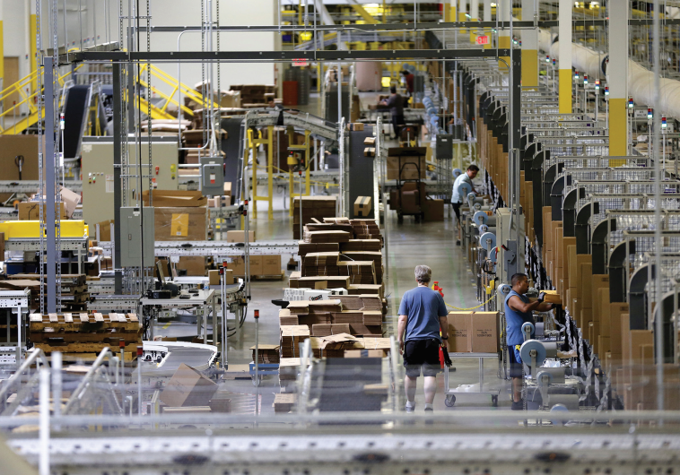 WORKERS SORT products at an Amazon Fulfillment Center in Tracy, California early this month