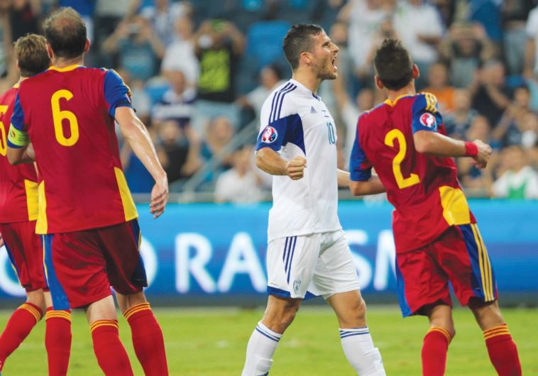 Israel striker Tomer Hemed (center) celebrates after scoring his team’s third goal 