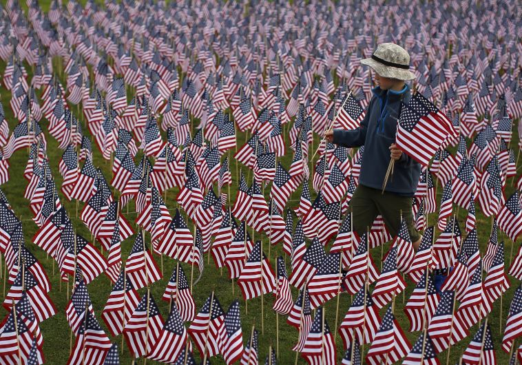 Boy among some of the 3,000 flags placed in memory of lives lost in the September 11, 2001 attacks, 