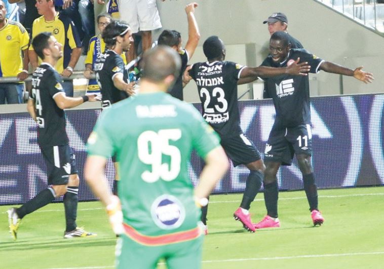 Hapoel Ra’anana players celebrate with striker Evans Kangwa (right)