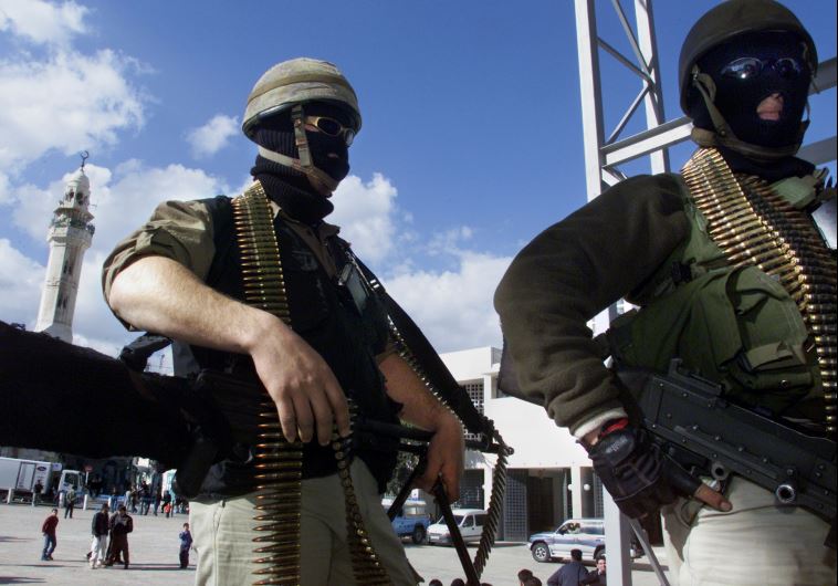 Heavily armed Palestinian Tanzim fighters congregate on a stage in Manger Square in Bethlehem