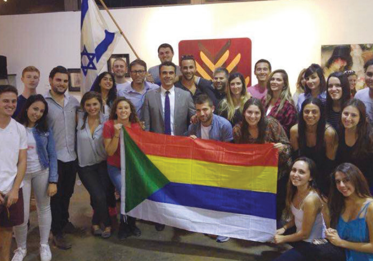 THE DELEGATION poses with Druse and Israeli flags in California.