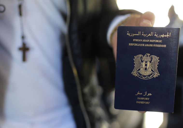 Christian Syrian refugee Ghassan Aleid displays his Syrian passport