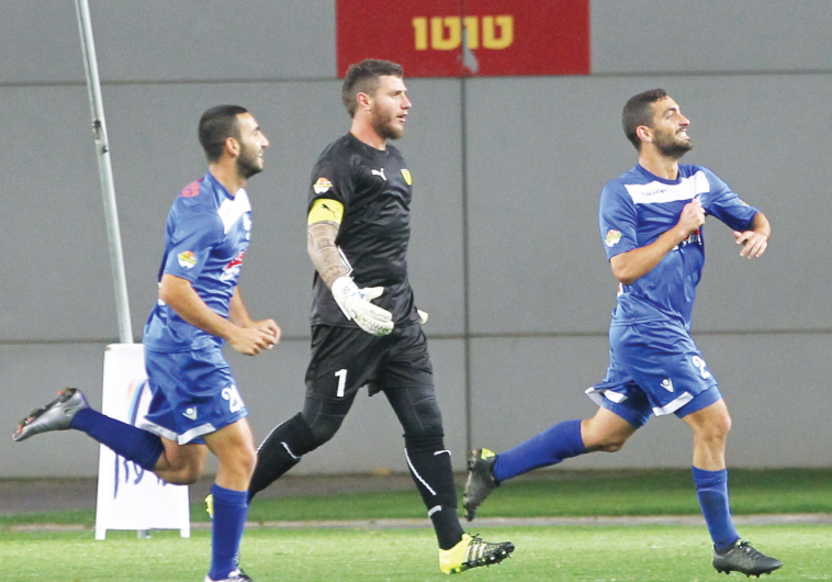 Maccabi Petah Tikva midfielder Gidi Kanyuk (right) celebrates after scoring past Beitar Jerusalem go