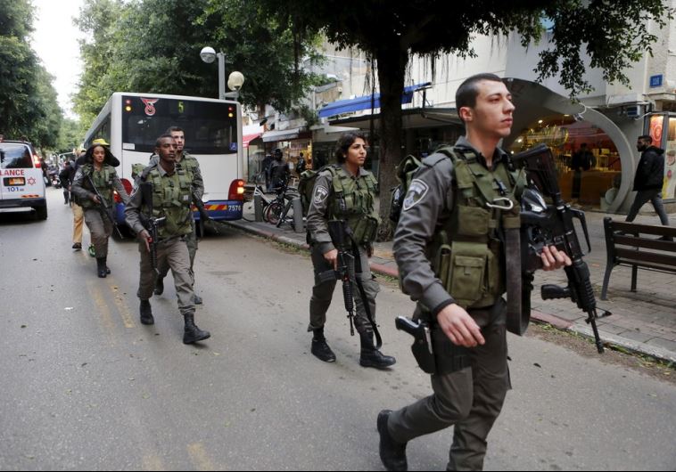 Israeli border police guards secure near the scene of a shooting incident in Tel Aviv