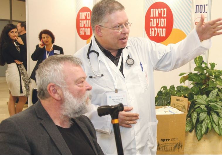 MK ILAN GILON (Meretz) hears an explanation from a physician at the Knesset yesterday